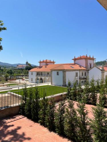 a group of plants in front of a building at Solar do Requeijo by Luna Hotels & Resorts in Arcos de Valdevez