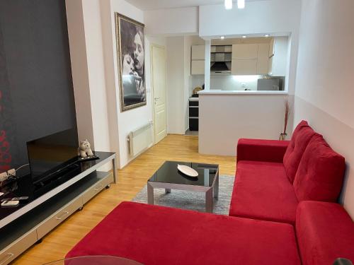 a living room with a red couch and a table at Apartment Alex in Ohrid