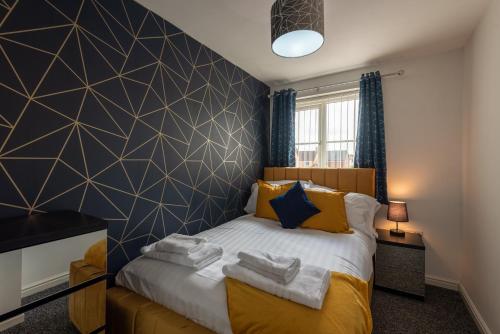 a bedroom with a bed with a black and white wall at Durham Gate View in Spennymoor