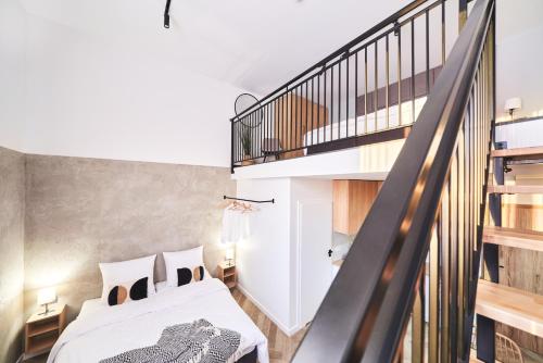 a room with a bed and a staircase at Na Fursie Apartments & Rooms in Nowy Targ