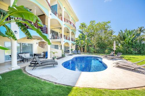 a house with a swimming pool in the yard at Salty Adventures at Twin Dolphins in Playa Flamingo