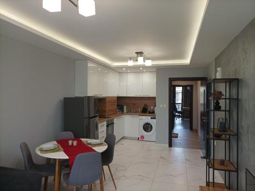 a kitchen and dining room with a table and chairs at One Bedroom Apartment 37- Trakia 54 А in Plovdiv