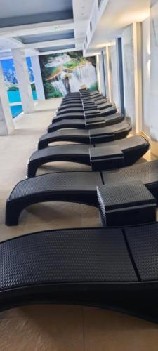 a row of black treadmills in a gym at President Kop Miki in Kopaonik