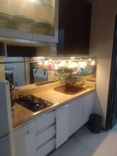a kitchen with a sink and a counter top at Apartment Thamrin City 1 Bedroom near Tanah Abang in Jakarta