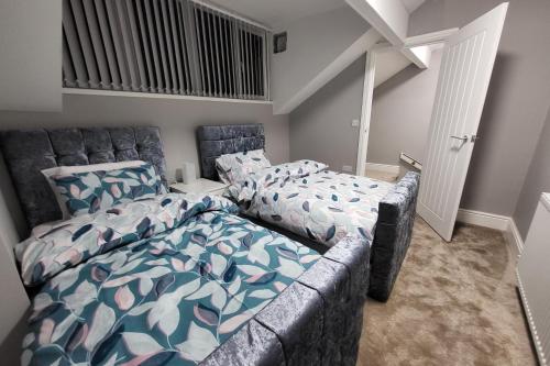 a bedroom with a bed and a couch in it at Park House Modernised 2 Bedroom Property in Knowsthorpe