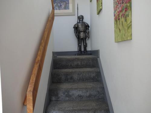 a stairway with a statue sitting on top of it at Claudius Caesar, Bowness-on-Solway in Bowness-on-Solway