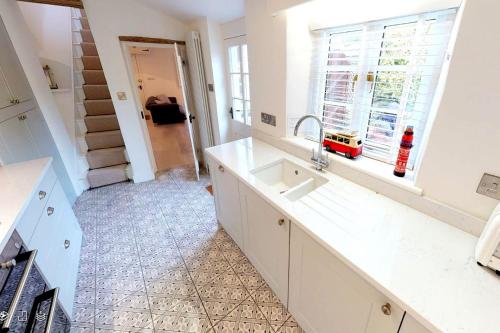 a kitchen with a sink and a window at CROYDE VICTORIA COTTAGE 2 Bedrooms in Croyde