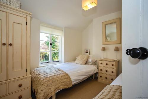 a bedroom with a bed and a window at CROYDE VICTORIA COTTAGE 2 Bedrooms in Croyde