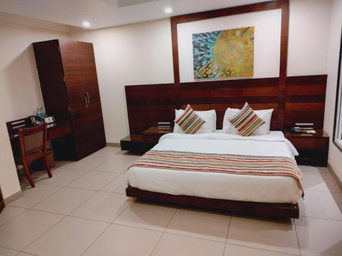 a bedroom with a large bed in a room at Regenta Central North Goa, Arpora in Arpora