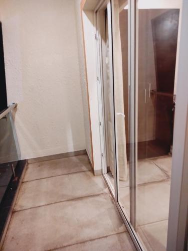 a hallway with a glass door in a room at Regenta Central North Goa, Arpora in Arpora