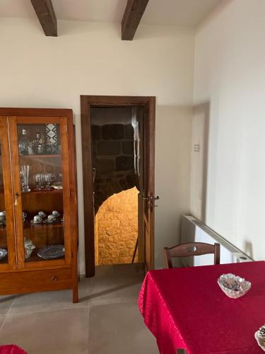 a dining room with a table and a glass door at B&B San Marco in San Lorenzello