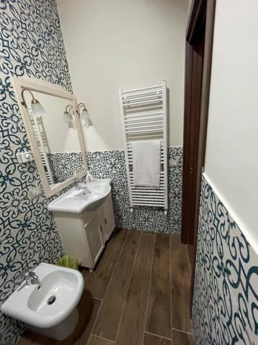 a bathroom with a sink and a toilet and a mirror at B&B San Marco in San Lorenzello