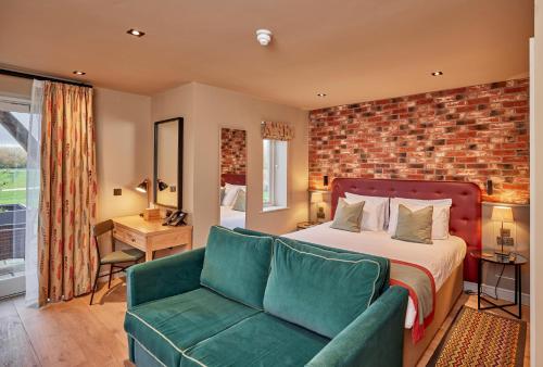 a hotel room with a bed and a couch at Sandburn Hall in York