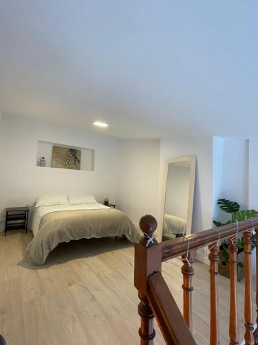 a bedroom with a bed and a mirror on the wall at Dúplex con impresionantes vistas in Monachil