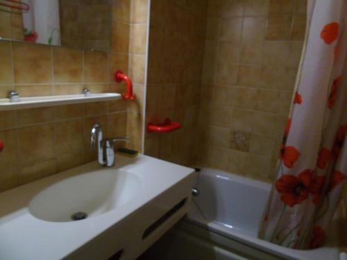 a bathroom with a sink and a shower curtain at Appartement Châtel, 2 pièces, 4 personnes - FR-1-198-113 in Châtel