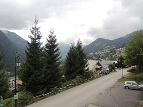 a street with trees on the side of a road at Charmant T2 avec mezzanine et balcon - 4 pers, parking, proche navettes, Châtel - FR-1-198-122 in Châtel