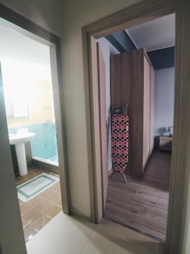 an open door of a room with a bathroom at Efrosini's by the sea apartment in Chalkida