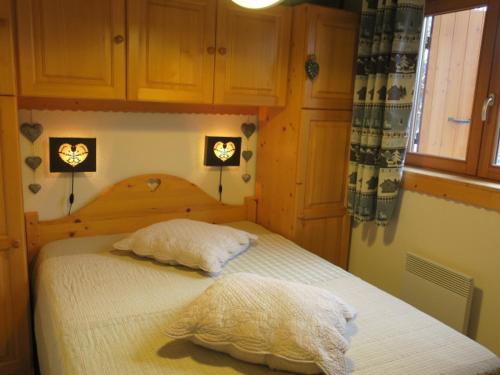 ein Schlafzimmer mit einem Bett mit zwei Kissen in der Unterkunft Appartement Châtel, 3 pièces, 4 personnes - FR-1-198-172 in Châtel