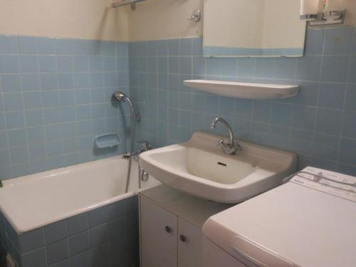 a bathroom with a sink and a bath tub at Appartement Châtel, 2 pièces, 4 personnes - FR-1-198-176 in Châtel