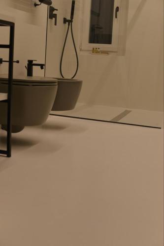a bathroom with a sink and a mirror at "A casa di Giacomo" Luxury Rooms con aria condizionata in Bergamo
