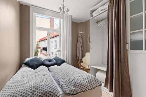 a bedroom with a bed and a large window at Hegdehaugsveien 1 in Oslo
