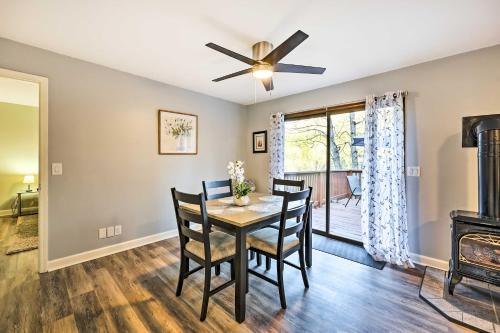 a dining room with a table and chairs and a ceiling fan at Holiday Island Home Mountain View and Hot Tub! in Holiday Island