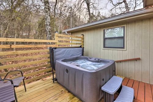 a hot tub on a deck with two chairs at Holiday Island Home Mountain View and Hot Tub! in Holiday Island