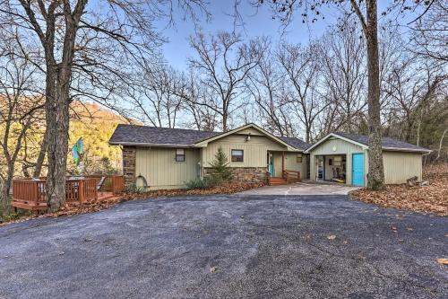 a home in the woods with a driveway at Holiday Island Home Mountain View and Hot Tub! in Holiday Island