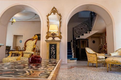 a living room with a table and chairs and a staircase at Dimora Villa Ricci in Pedaso