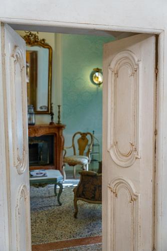 an open door into a living room with a fireplace at Dimora Villa Ricci in Pedaso