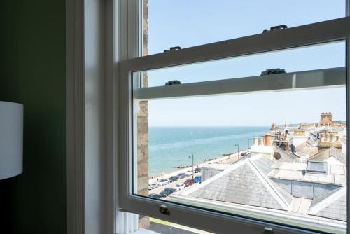 a window with a view of the beach at Luxury Duplex Penthouse on the Beach with Panoramic Sea Views in Herne Bay