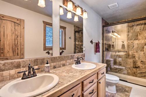 a bathroom with two sinks and a shower and a toilet at 22STR-00367 Fairplay Cabin ~ 6 Mi to Downtown! in Fairplay