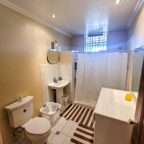 a bathroom with a toilet and a sink at 1 Bed Apt overlooking Rodney Bay in Gros Islet