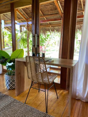 a wooden desk with a chair in a room at AWERA RESORT in Tua Pejat