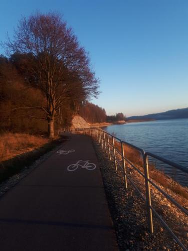a bike path next to a body of water at Domek na Hubce II in Maniowy