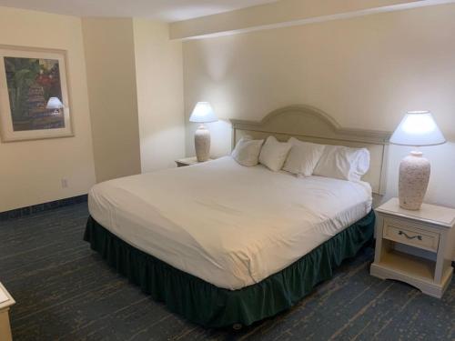 a hotel room with a large bed with two lamps at Coastal Hideaway Oceanview Condo in Daytona Beach