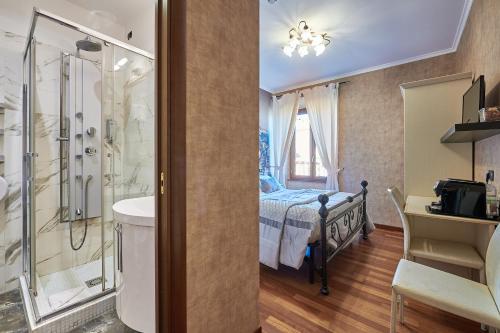 a bathroom with a shower and a bedroom with a bed at Le Suite Downtown in Rome