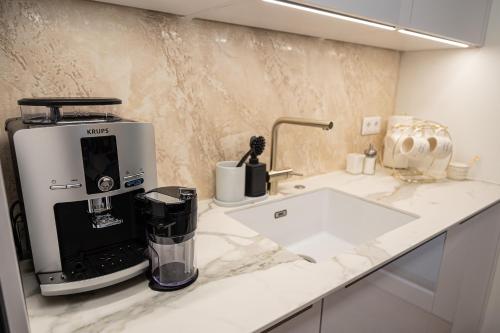 a kitchen with a coffee maker on a counter at Ferienwohnung Deluxe Sattendorf in Sattendorf