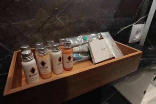 a wooden shelf with four bottles of hair products at Joumaya Luxury Gauthier in Casablanca