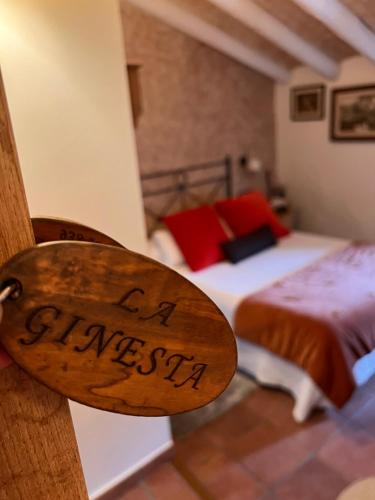 a bedroom with a bed with a sign that reads la grosse commission at El Molí de Pontons suites con jacuzzi spa in Pontons