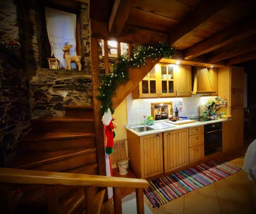 a kitchen with a christmas tree in a cabin at Talasnal Casa do Cascão in Lousã