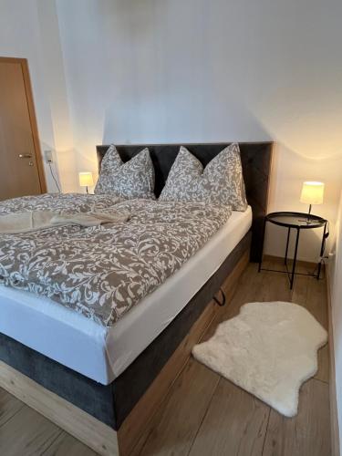 a bedroom with a large bed with pillows at Ferienwohnung Broschek in Flachau