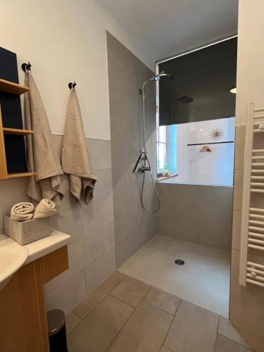 a bathroom with a shower with towels on the wall at Ferienwohnung Broschek in Flachau