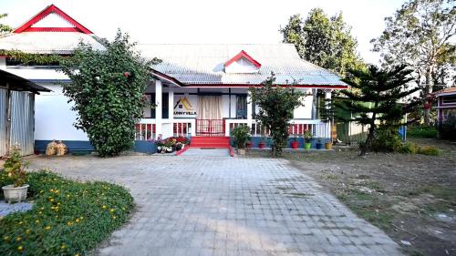 a house with a dog sitting in front of it at Sunny Villa in Sivasagar