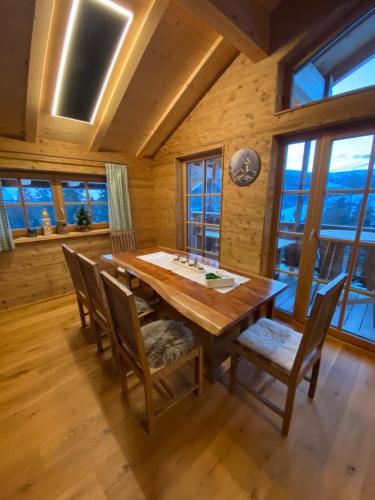 a dining room with a wooden table and chairs at Jagdhütte in Lachtal