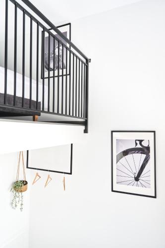 a living room with a staircase and a framed picture at Na Fursie Apartments & Rooms in Nowy Targ