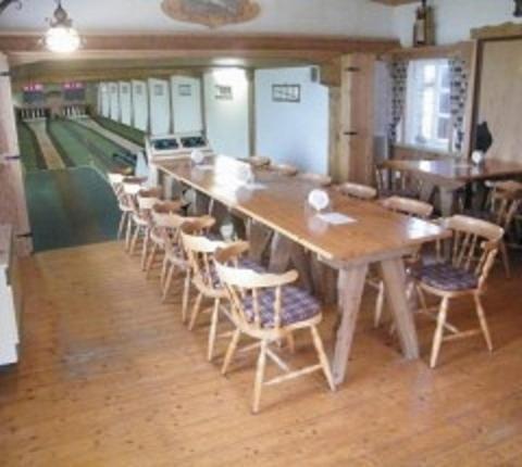 a long wooden table and chairs in a room at Waldhotel Dornröschenshöh in Hemfurth-Edersee