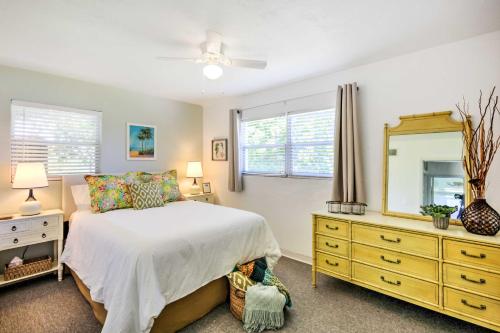 a bedroom with a bed and a dresser and a mirror at Cozy NSB Abode with BBQ and Fire Pit - Walk to Beach! in New Smyrna Beach