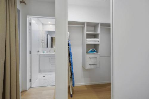 baño con ducha a ras de suelo junto a un armario en 3 Bdrm Mangere Delight - Parking - Wi-Fi - Netflix, en Auckland