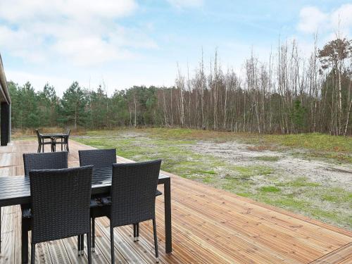 a wooden deck with a table and chairs on it at 8 person holiday home in Læsø-By Traum in Læsø